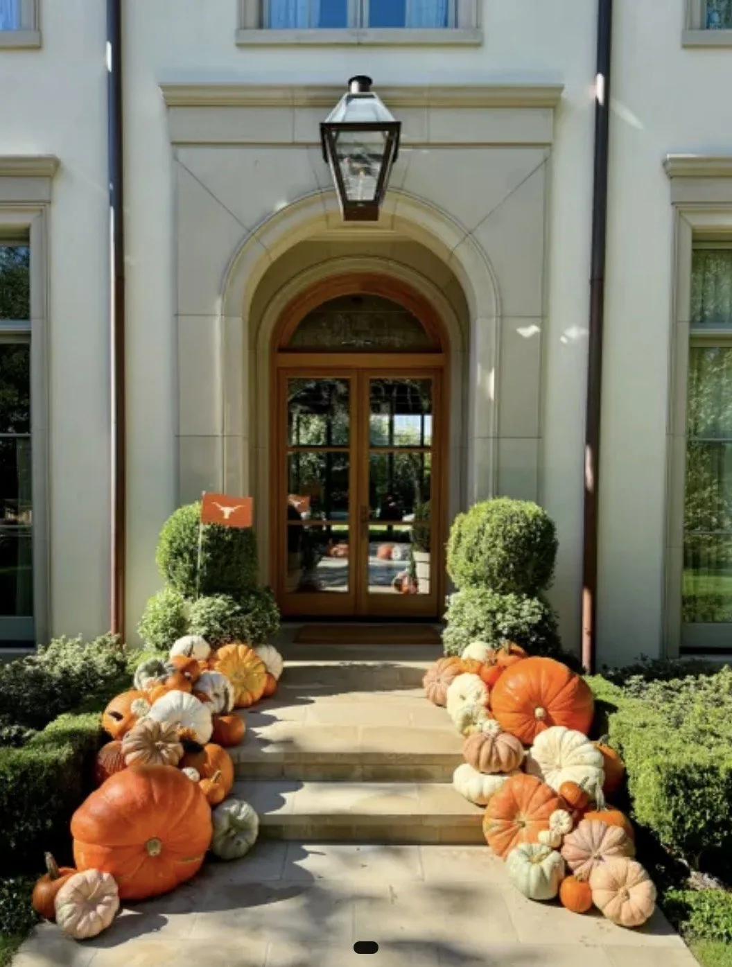 Grand entrance with roughly 60 to 75 real uncarved pumpkins flowing down a wide staircase